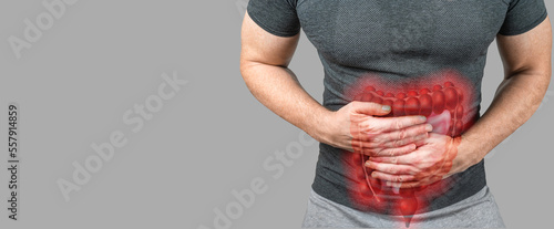 Intestinal inflammation. Abdominal pain man, photo of large intestine on man body, stomachache diarrhea symptom or food poisoning. gray background, copy space photo