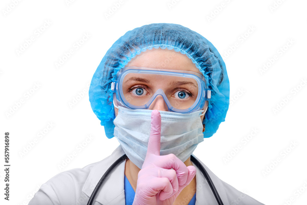 A doctor in a protective mask and clothes from a coronavirus put a finger to her lips with a gesture of secret, isolated on a white background. Nurse on a in pink medical gloves.