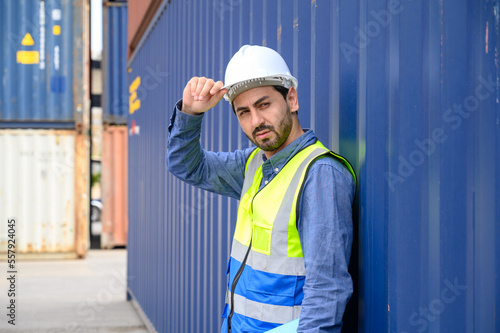 Portrait of foreman or worker working holding clipboard at Container cargo site checkup goods in container. import export shipping business concept.