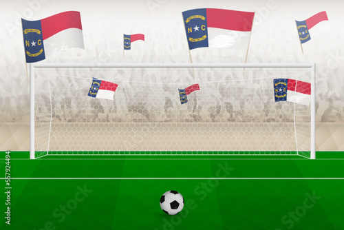 North Carolina football team fans with flags of North Carolina cheering on stadium, penalty kick concept in a soccer match.