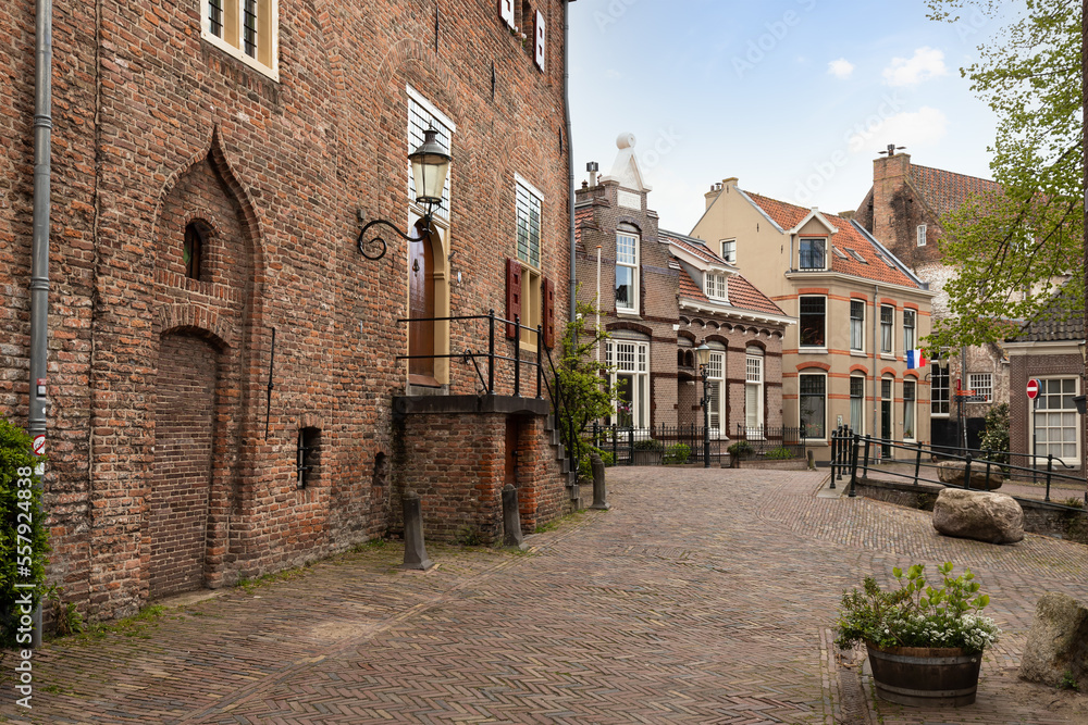Fototapeta premium Narrow street with Dutch flags in the old medieval center of the Dutch city of Amersfoort.