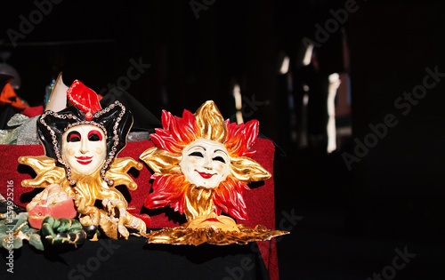Fototapeta Naklejka Na Ścianę i Meble -  Vintage Venetian masks at flea market in Venice. Sale of antique masks for tourists during the carnival days. Street, sunny day. Close-up. Selective focus.