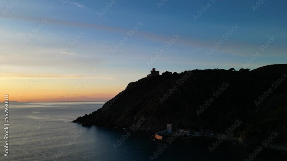 Aerial view of a castle on a cliff in sunset silhouette Aerial view of a castle on a cliff in sunset silhouette
