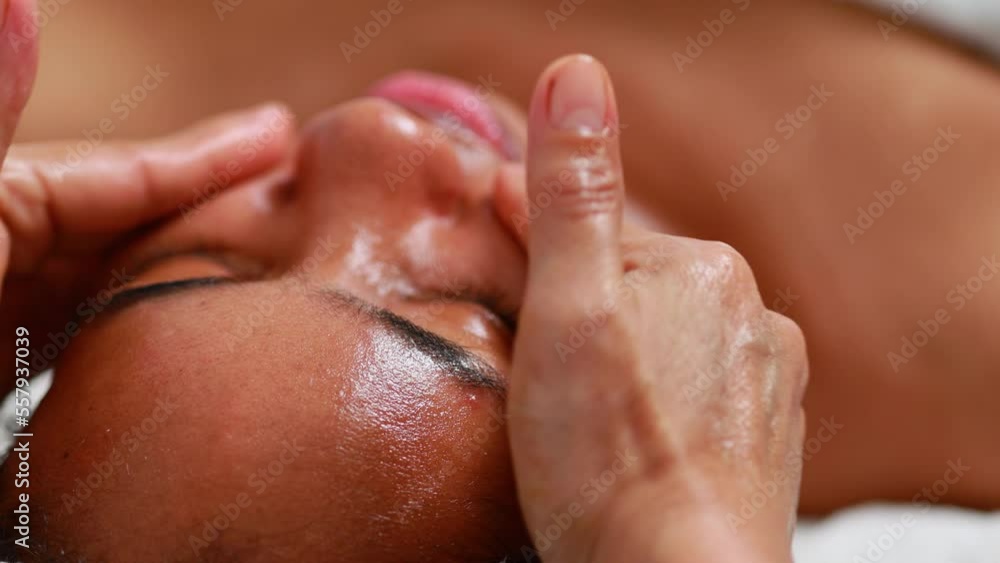 facial treatment. Beautiful African American woman getting face massage in beauty spa and wellness center. Facial treatment and skin care concept. facial treatment. Beautiful African American woman getting face massage in beauty spa and wellness center. Facial treatment and skin care concept.