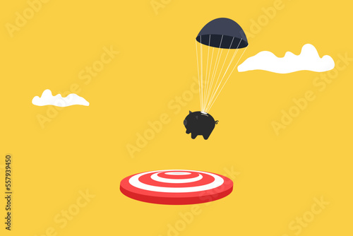 piggy bank with parachute landing on the target. concept of goal, opportunity and success