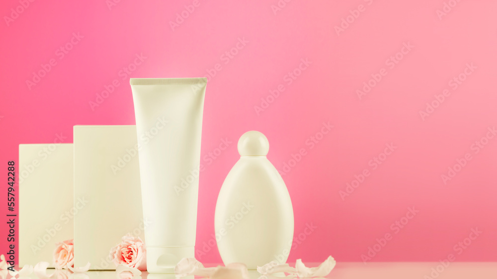 Mock up of natural beauty products based on rose flowers. White cosmetic tube and bottle with white boxes on pink gradient background with tender roses and rose petals. Soft focus style, copy space Mock up of natural beauty products based on rose flowers. White cosmetic tube and bottle with white boxes on pink gradient background with tender roses and rose petals. Soft focus style, copy space