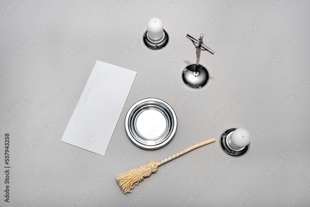 A steel caroling set lying on a gray tablecloth, traditional priest caroling in Poland, with an envelope with money. A steel caroling set lying on a gray tablecloth, traditional priest caroling in Poland, with an envelope with money.