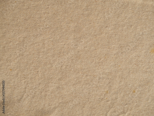Old vintage paper background texture. Close-up of brown cardboard paper with a rough fibrous texture of the background surface