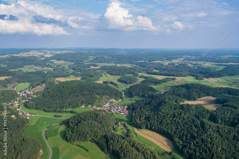 View from a motor glider over the picturesque landscape of Franconian Switzerland/Germany with small villages