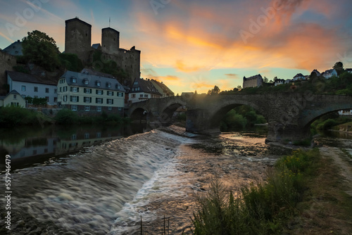 View over the rapids of the Lahn towards Runkel Castle/Germany at sunset