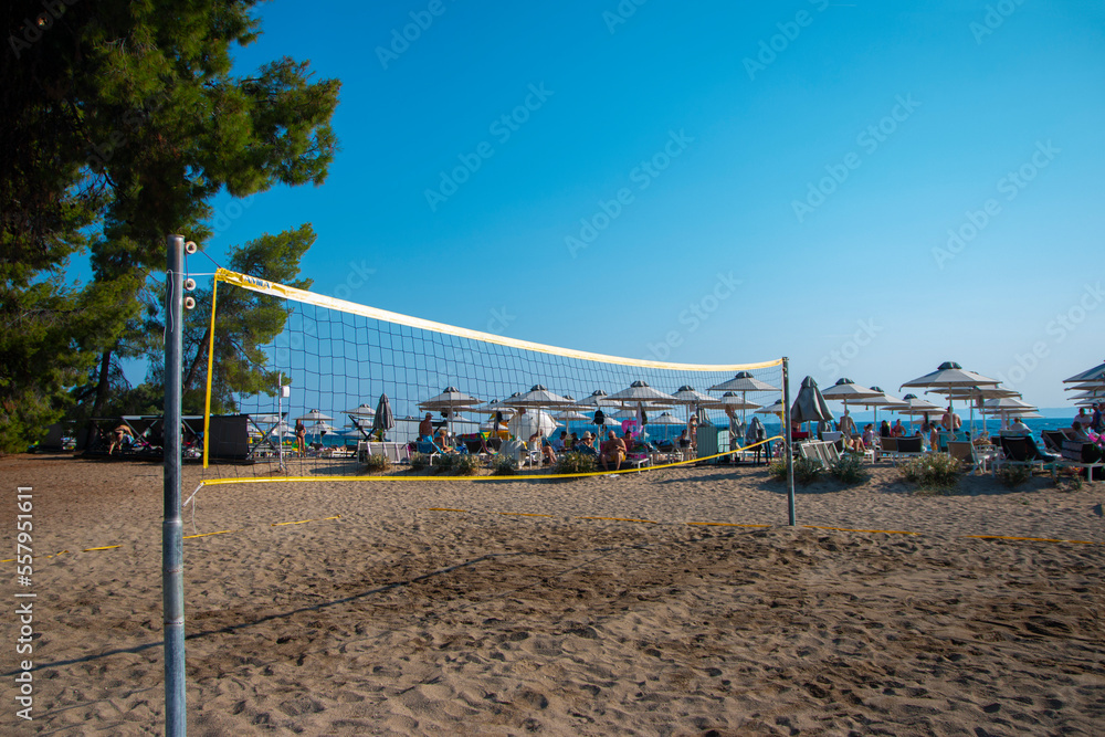 Volleyball net on sand in summer background. Outdoor leisure games. Active lifestyle on beach with sand near sea or ocean with sky.