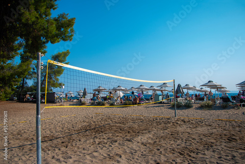 Volleyball net on sand in summer background. Outdoor leisure games. Active lifestyle on beach with sand near sea or ocean with sky.
