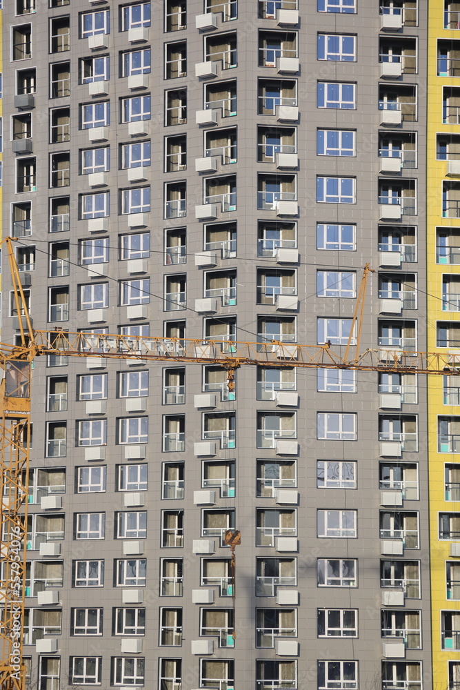 urban modern landscape and multi-colored new buildings residential buildings, windows, air conditioners, facades in winter, Biryulovo, Moscow, January 2023.