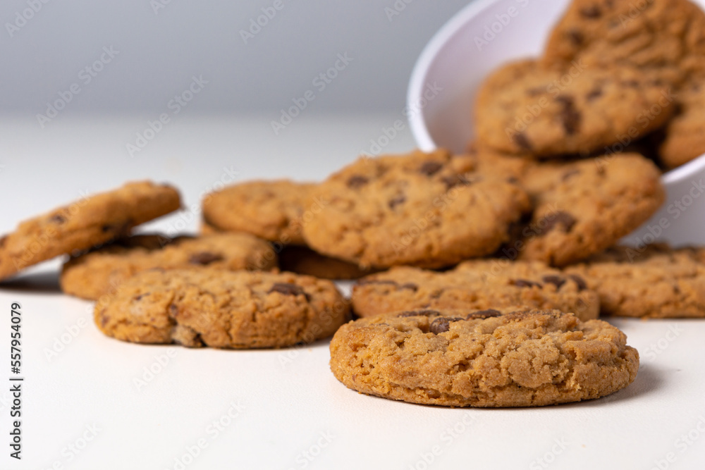 cookies falling from bowl on the table, isolated on white background cookies falling from bowl on the table, isolated on white background