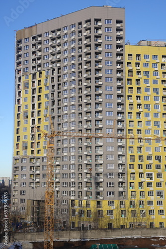 urban modern landscape and multi-colored new buildings residential buildings, windows, air conditioners, facades in winter, Biryulovo, Moscow, January 2023.