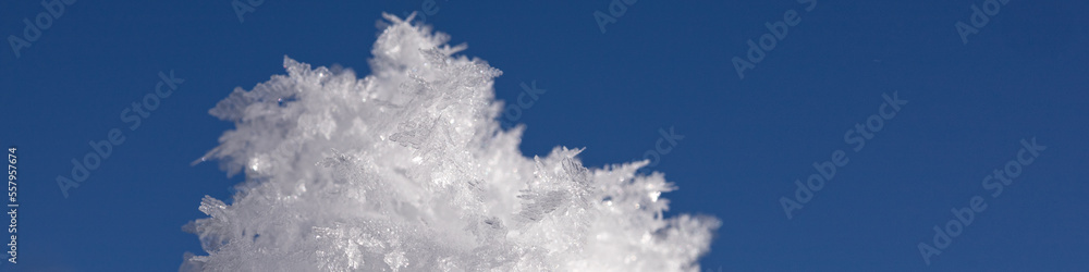 Fototapeta premium Banner 4:1 with snowflakes and ice floes against a dark blue sky
