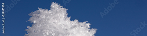 Banner 4:1 with snowflakes and ice floes against a dark blue sky © Anna
