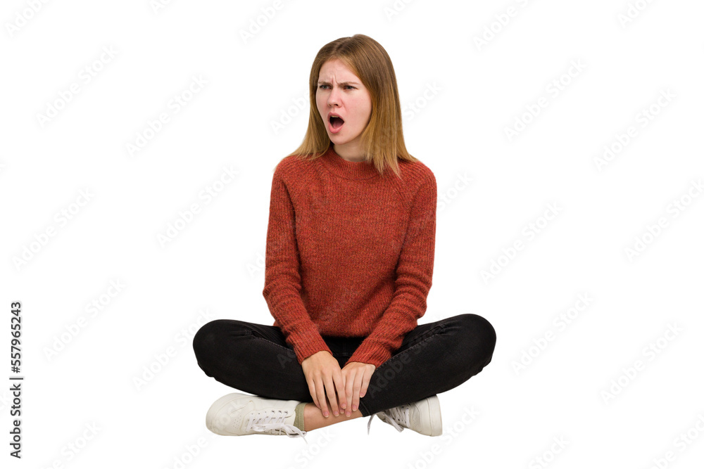 Young caucasian woman sitting on the floor cutout isolated Young caucasian woman sitting on the floor cutout isolated
