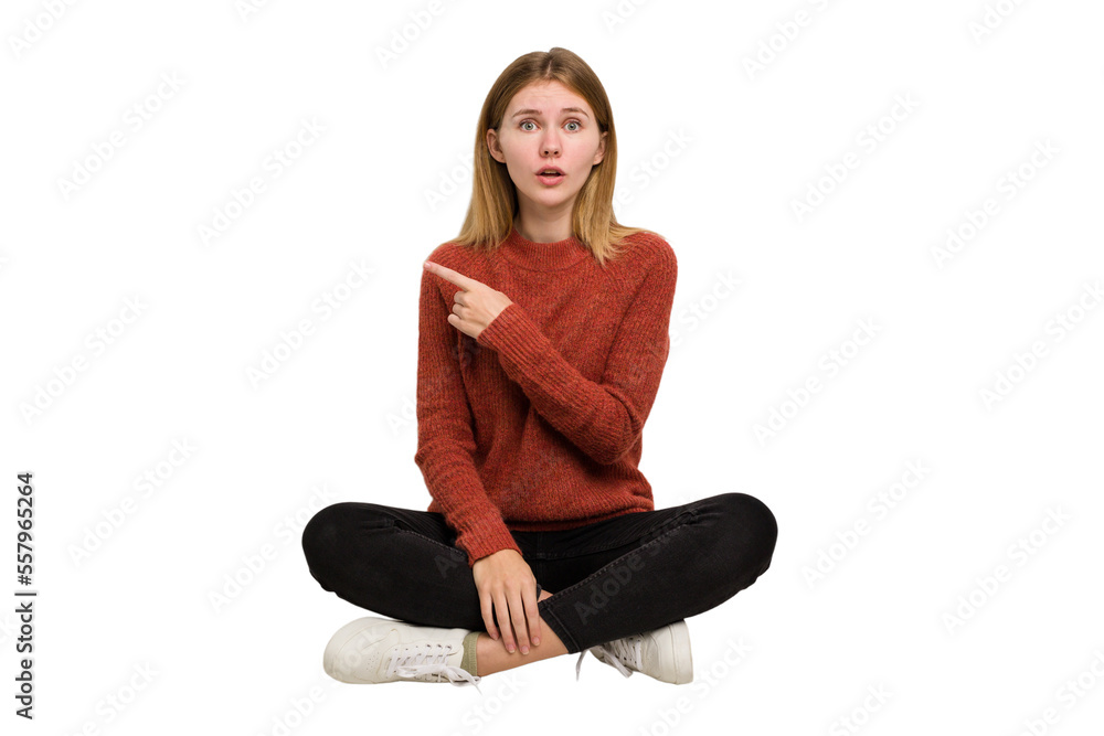 Young caucasian woman sitting on the floor cutout isolated Young caucasian woman sitting on the floor cutout isolated