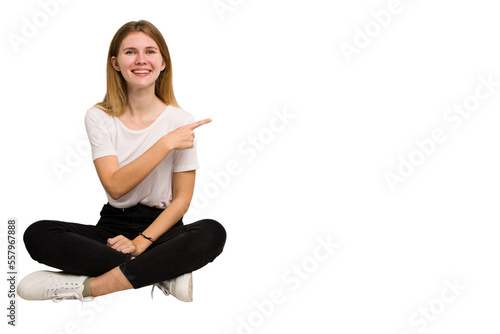 Young caucasian woman sitting on the floor cutout isolated