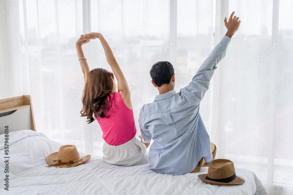 Fototapeta premium Asian couples are preparing to travel together both domestically and internationally. Have a good travel plan through the Internet. Both of them are happy and excited about going on a trip together.