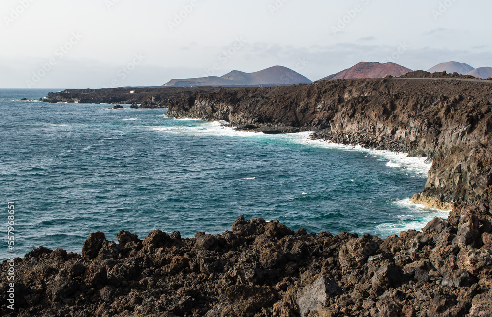 Breathtaking view from the coast overlooking the sea. Crystal clear sea, wind and waves crashing on the rocks.
Lanzarote, Canary Island, Spain.