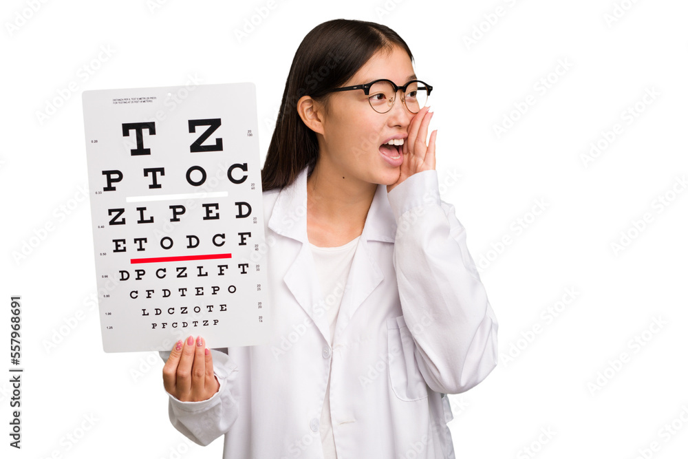 Young asian oculist woman holding a eye chart paper isolated shouting and holding palm near opened mouth. Young asian oculist woman holding a eye chart paper isolated shouting and holding palm near opened mouth.
