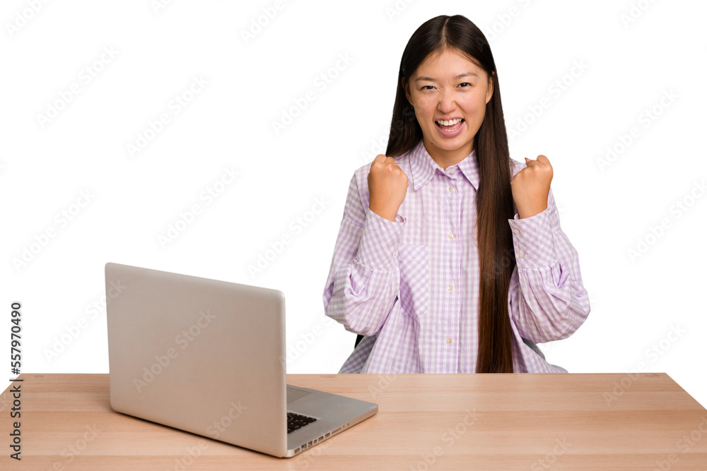 Young student asian woman in a workplace with a laptop isolated cheering carefree and excited. Victory concept. Young student asian woman in a workplace with a laptop isolated cheering carefree and excited. Victory concept.