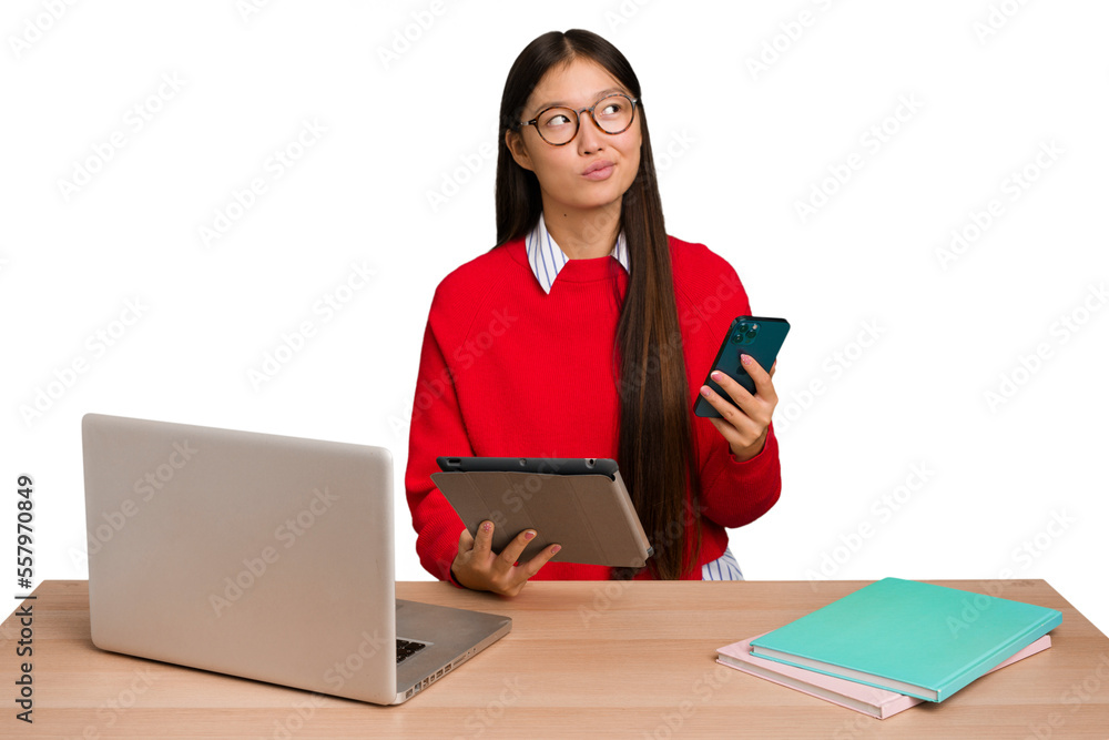 Young student asian woman in a workplace with a laptop isolated Young student asian woman in a workplace with a laptop isolated