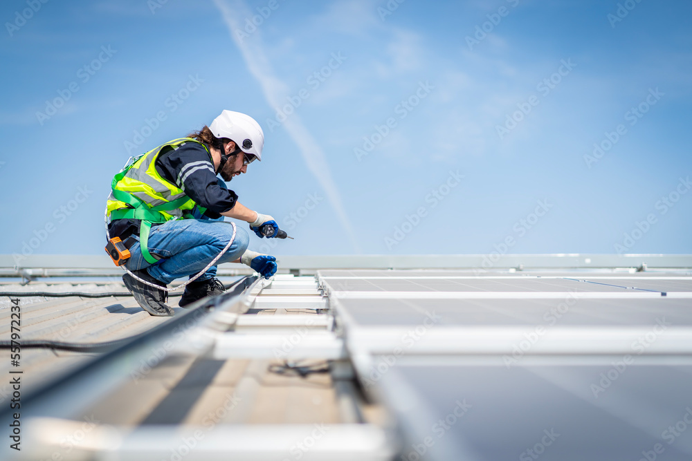 Male engineer installing or checking the working condition of solar panels on the roof or at the height of the factory for saving electricity was broken to use renewable energy from the sun Male engineer installing or checking the working condition of solar panels on the roof or at the height of the factory for saving electricity was broken to use renewable energy from the sun
