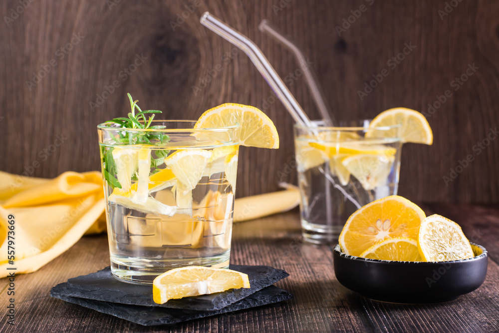 Fototapeta premium Water with lemon and rosemary in glasses on the table. Detox drink