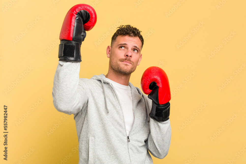 Adult man boxing isolated on yellow background Adult man boxing isolated on yellow background