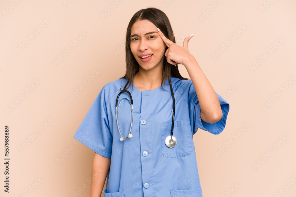 Young nurse colombian woman isolated showing a disappointment gesture with forefinger. Young nurse colombian woman isolated showing a disappointment gesture with forefinger.