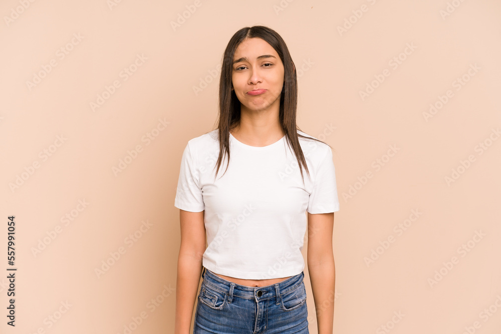 Young colombian woman isolated on beige background sad, serious face, feeling miserable and displeased. Young colombian woman isolated on beige background sad, serious face, feeling miserable and displeased.