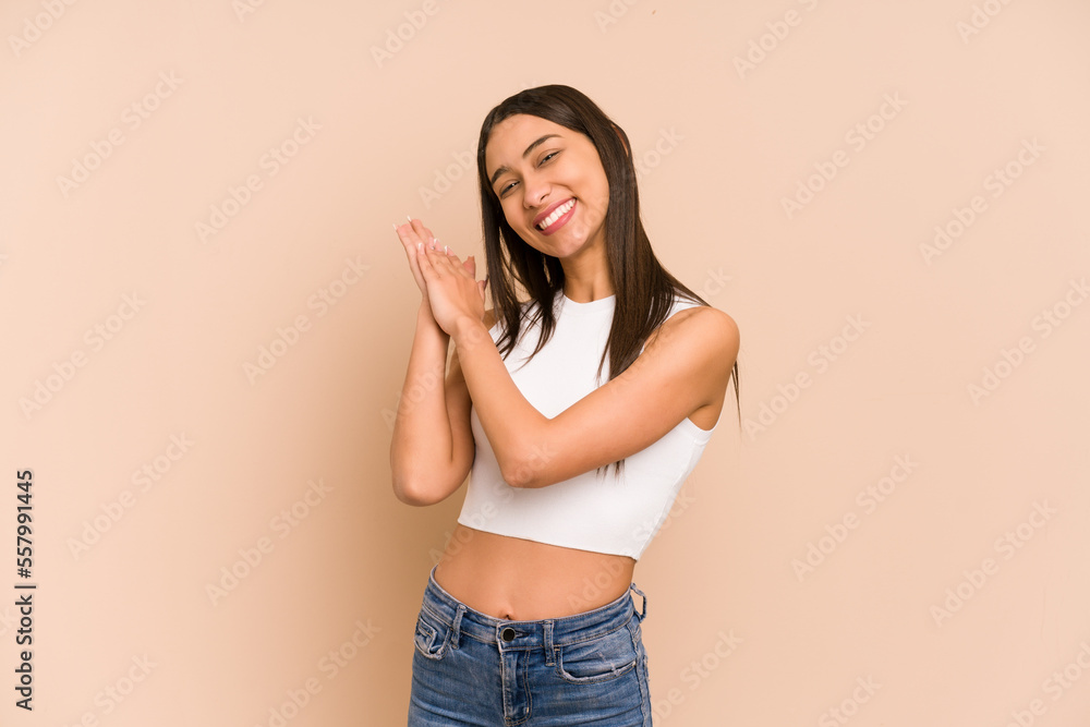Young colombian woman isolated on beige background feeling energetic and comfortable, rubbing hands confident. Young colombian woman isolated on beige background feeling energetic and comfortable, rubbing hands confident.