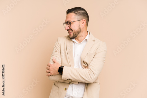 Adult latin business man cut out isolated smiling confident with crossed arms. © Asier