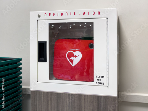 Automated External Defibrillator (AED) in a box on the wall in a public building. Emergency pacemaker device for people with cardiac arrest.