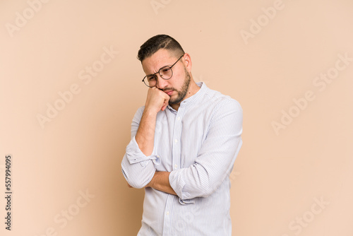 Adult latin man cut out isolated who feels sad and pensive, looking at copy space.