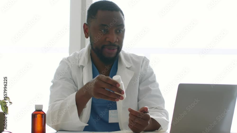 Young african american therapist video chatting with patient online on laptop, recommending new pills, free space Young african american therapist video chatting with patient online on laptop, recommending new pills, free space