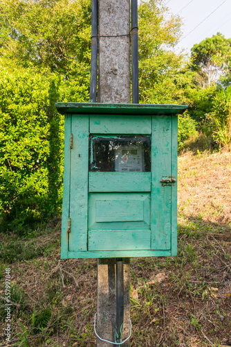 Old style wooden electricity pole with wooden energy meter box in the countryside of Sao Francisco de Paula, Brazil
