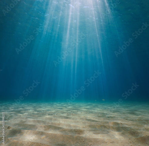 Murais de parede Rays of sunlight underwater with a sandy seabed in the Mediterranean sea, Spain