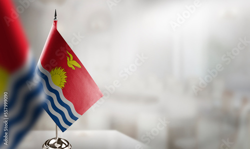 Small flags of the Kiribati on an abstract blurry background