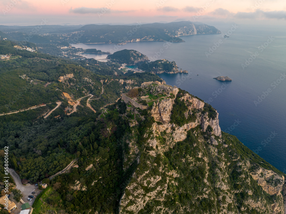Aerial drone view of iconic medieval fortified castle of Agelokastro with amazing views to Paleokastritsa bay, Corfu Greece