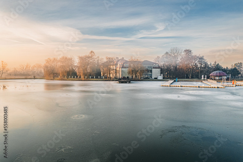 Zima nad stawem w Zebrzydowicach z pięknym parkiem pałacowym na Śląsku w Polsce, panorama z lotu ptaka photo