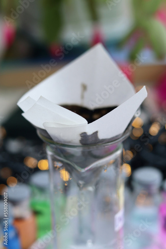 A paper filter through which the black inorganic substance copper sulfide is slowly filtered.