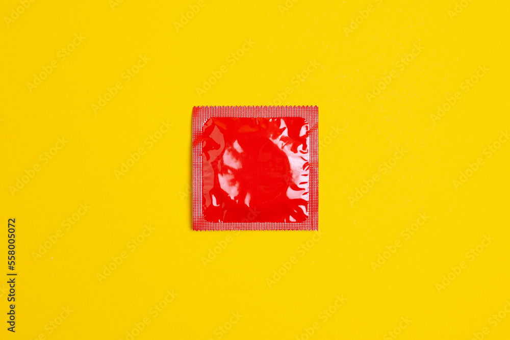 condom lie on a yellow background, the concept of safe sex condom lie on a yellow background, the concept of safe sex