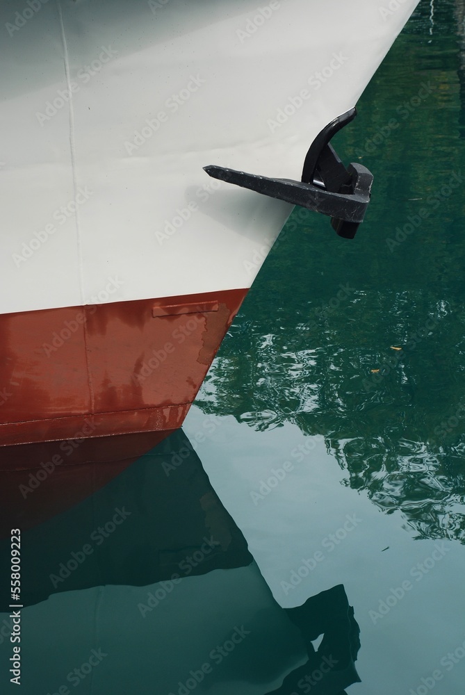 A simple, minimalistic photograph of the prow of a ship anchored in the Aare River, in autumn.
