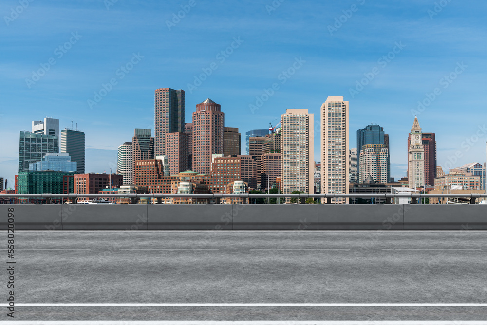 Empty urban asphalt road exterior with city buildings background. New modern highway concrete construction. Concept of way to success. Transportation logistic industry fast delivery. Boston. USA.