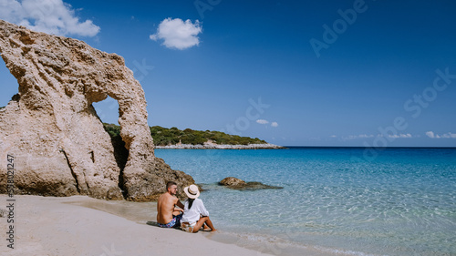 couple visit the Tropical beach of Voulisma beach, Istron, Crete, Greece during vacation,Most beautiful beaches of Crete island -Istron bay near Agios Nikolaos  photo