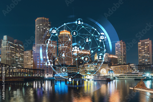 City view panorama of Boston Harbor and Seaport Blvd at night time, Massachusetts. Exteriors of financial downtown. The concept of networking and establishing new business connections between people